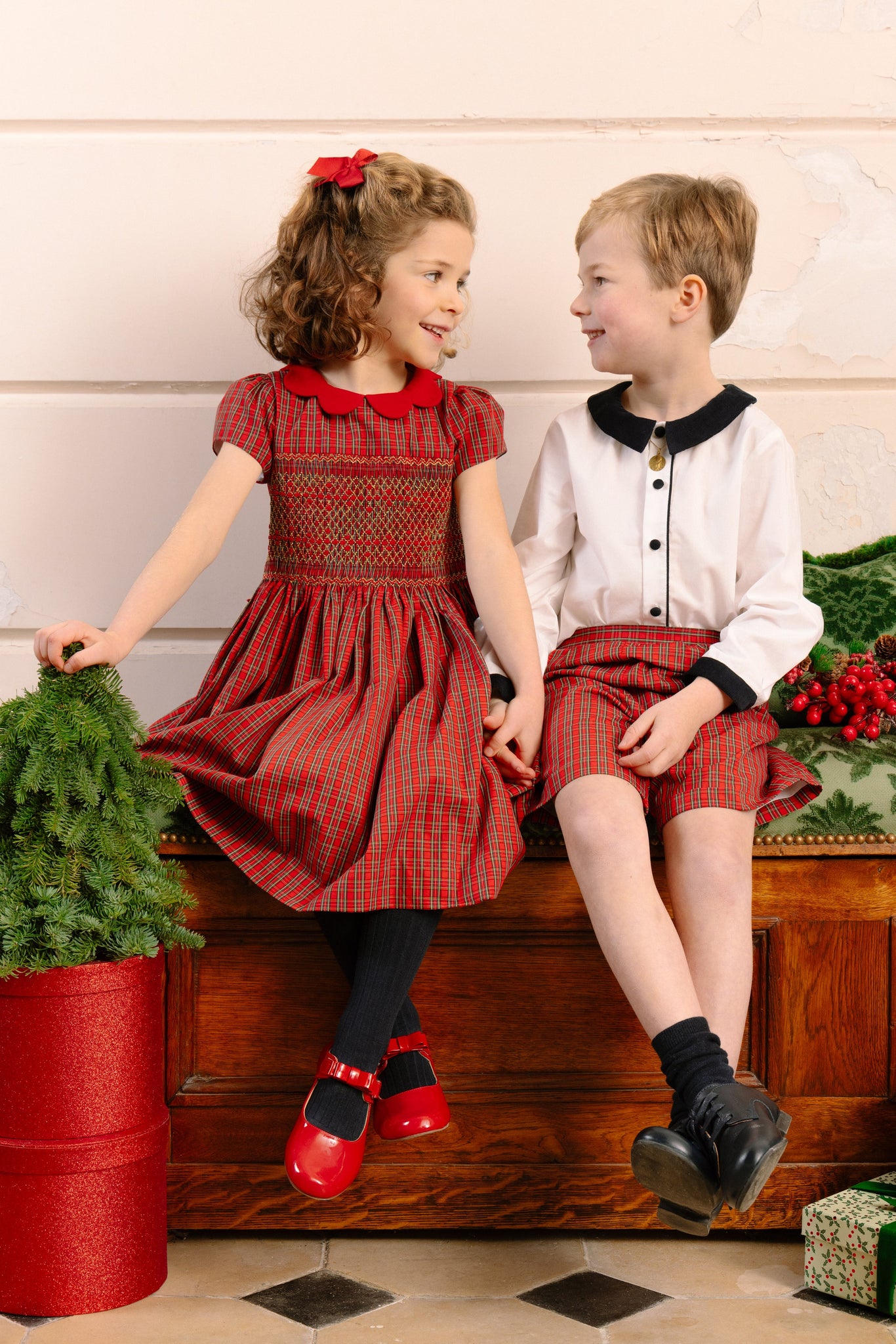Girl and boy in holiday clothes sitting together
