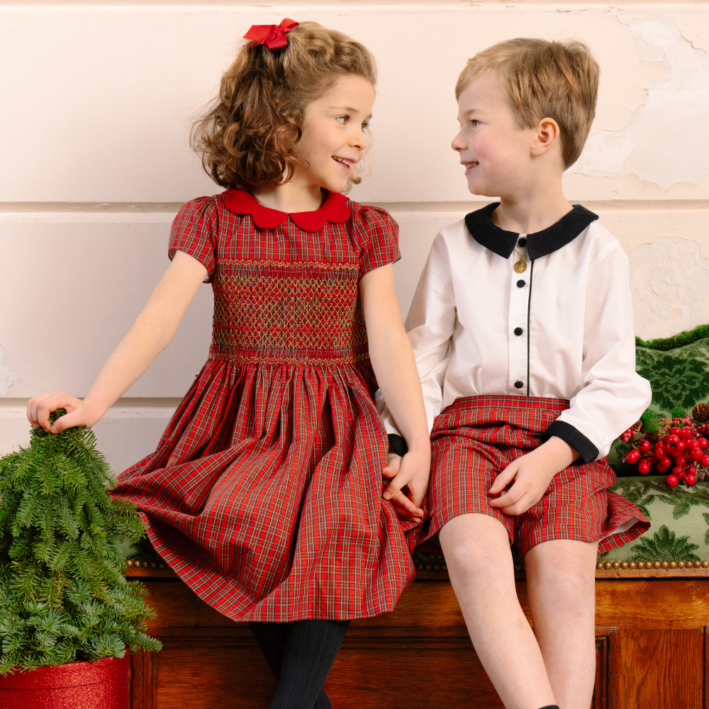 Girl and boy in holiday clothes sitting together
