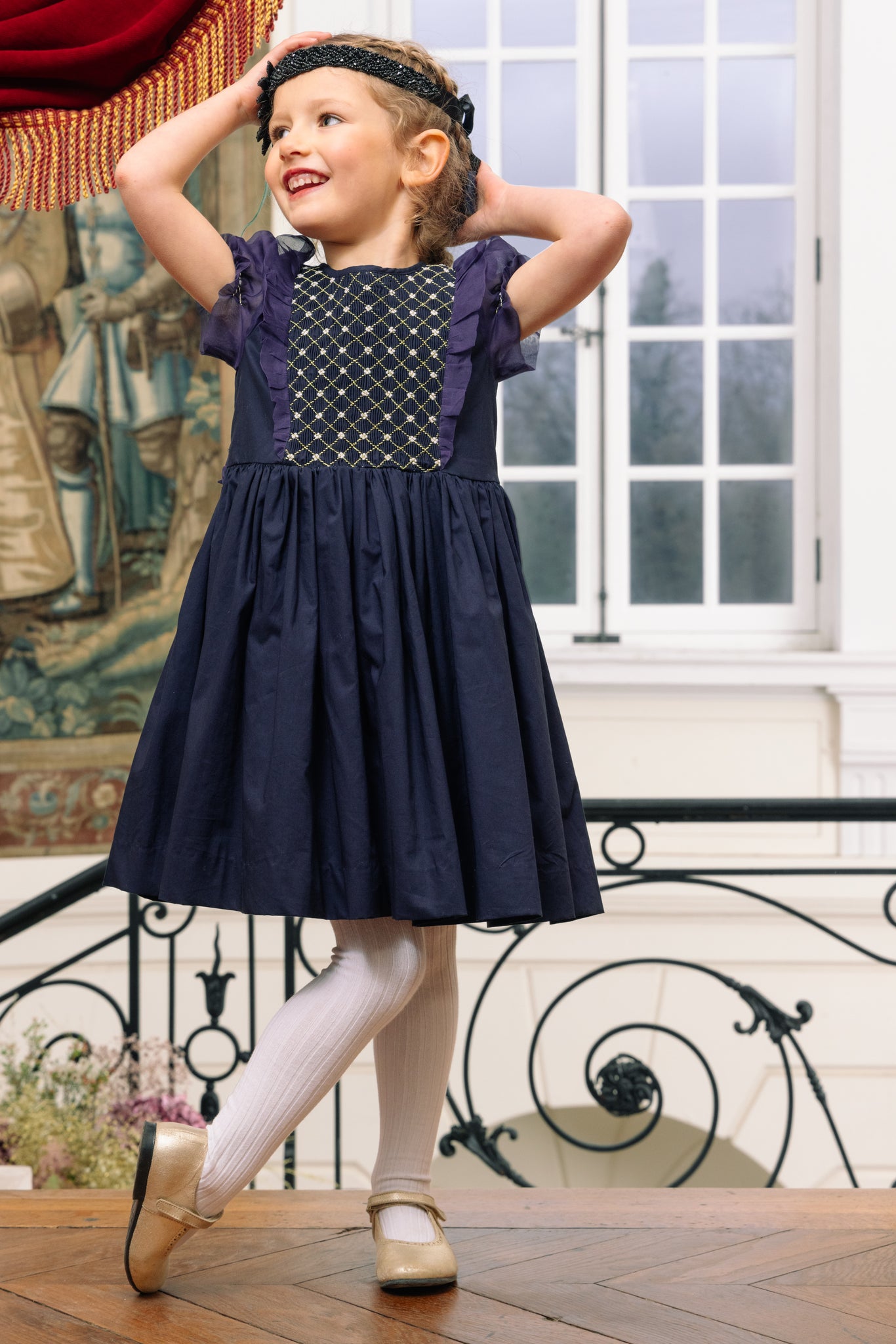 Girl wearing Camelia Navy Cotton Smocked Dress