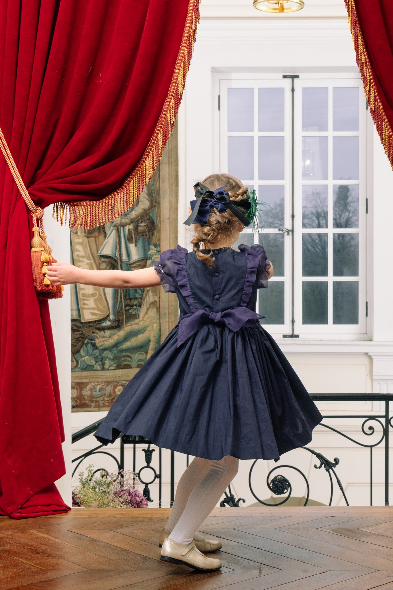 Back of girl wearing Camelia Navy Cotton Smocked Dress