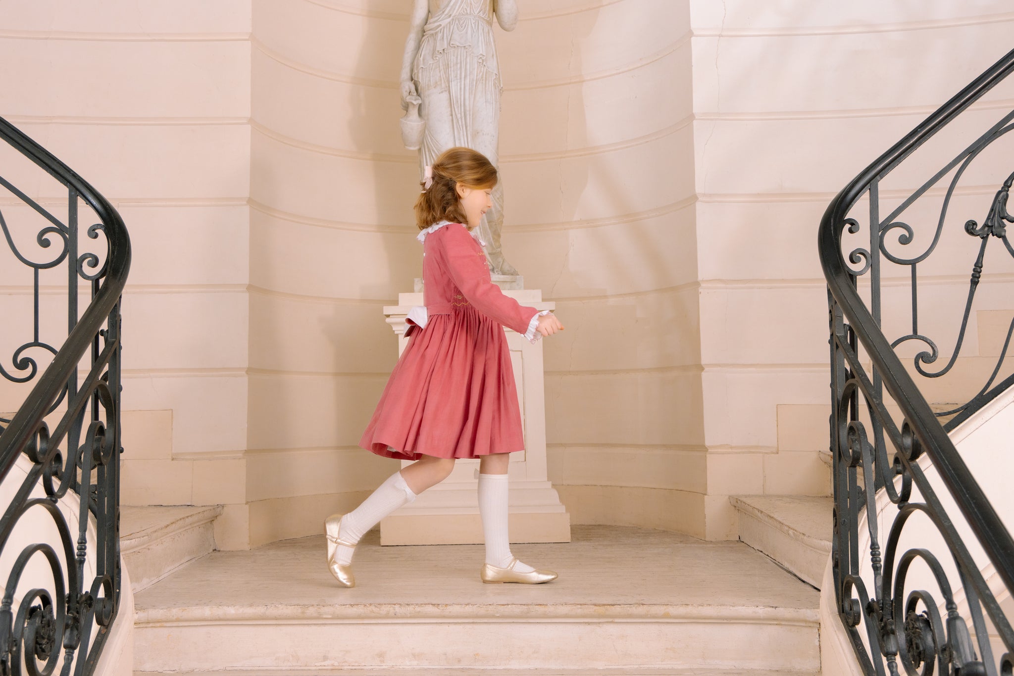 Young girl wearing Chiara Pink Smocked Dress