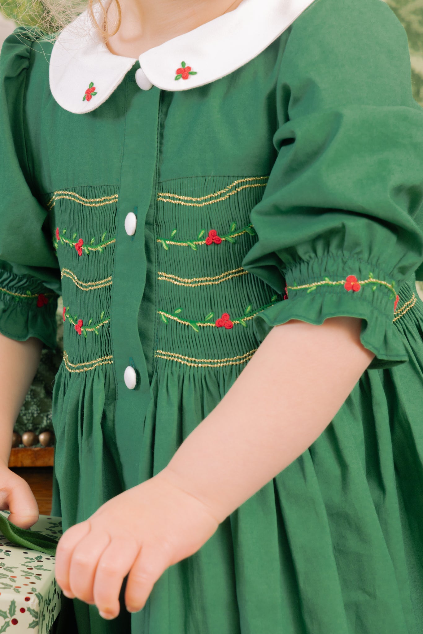 Close-up of smocking details and sleeves of Olympe Green Smocked Christmas Dress