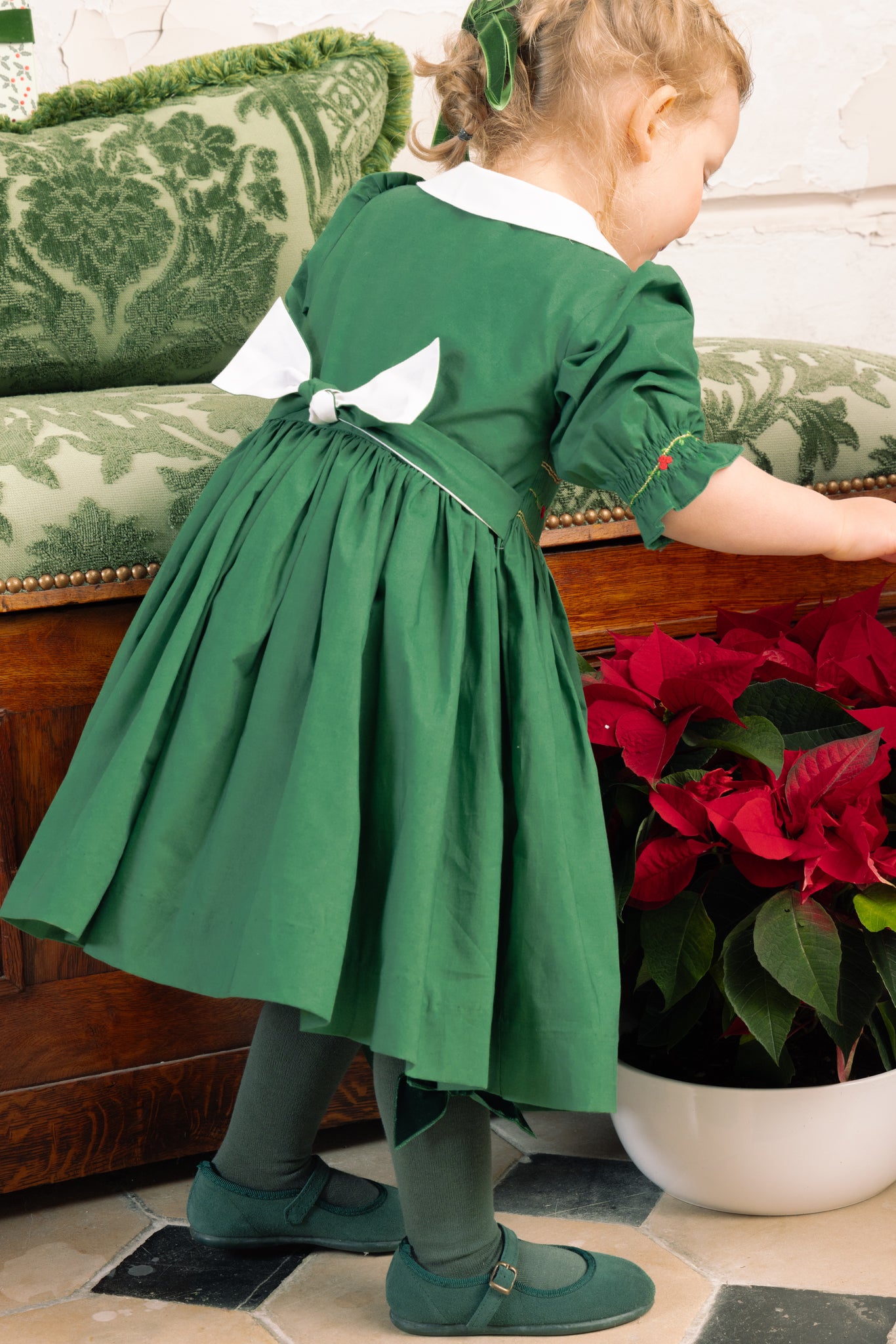 Back of girl wearing Olympe Green Smocked Christmas Dress